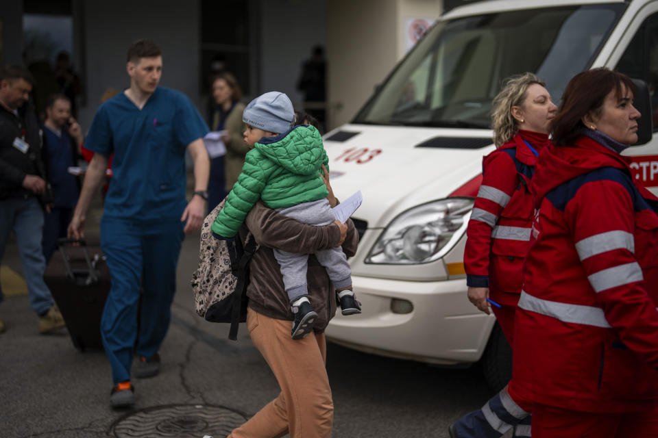 Patients are evacuated from Children's Hospital No. 1 on the outskirts of Kyiv, Ukraine, Friday, April 26, 2024. Doctors and ambulance crews evacuated patients from a Kyiv children's hospital on Friday after a video circulated online saying Russia planned to attack it. (AP Photo/Francisco Seco)