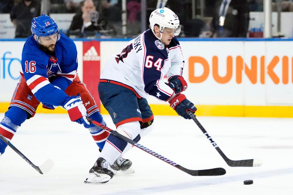 Columbus Blue Jackets' Trey Fix-Wolansky (64) drives past New York Rangers' Vincent Trocheck (16) during the second period of an NHL hockey game Tuesday, March 28, 2023, in New York. (AP Photo/Frank Franklin II)