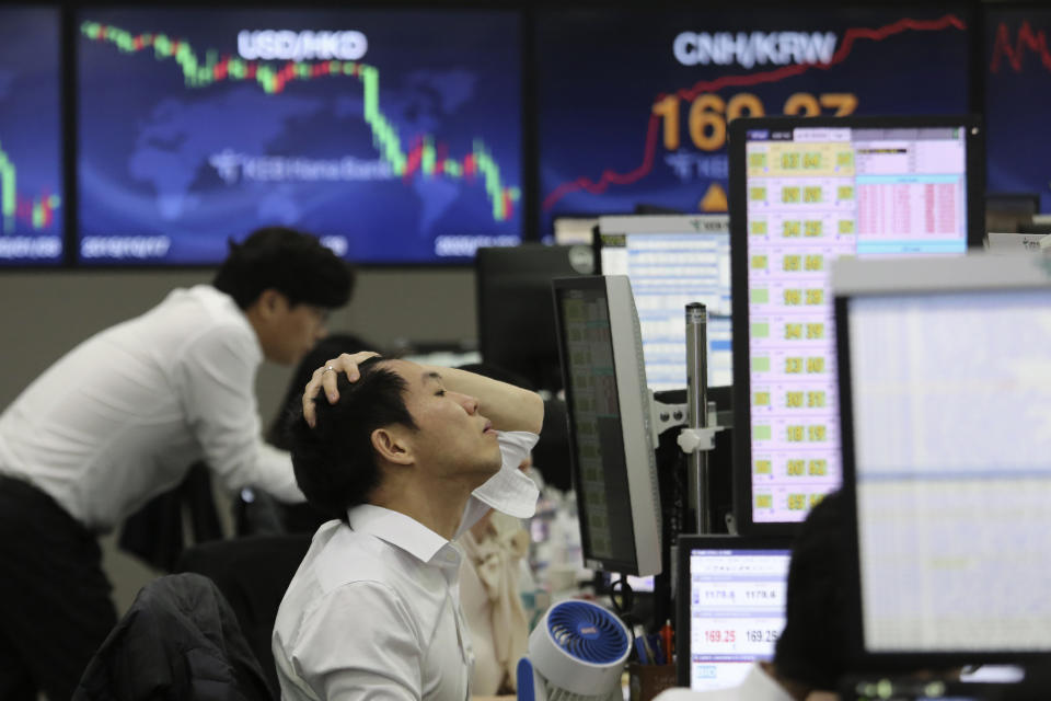 A currency trader watches monitors at the foreign exchange dealing room of the KEB Hana Bank headquarters in Seoul, South Korea, Wednesday, Jan. 8, 2020. Oil prices rose and Asian stock markets fell Wednesday after Iran fired missiles at U.S. bases in Iraq in retaliation for the killing of an Iranian general. (AP Photo/Ahn Young-joon)