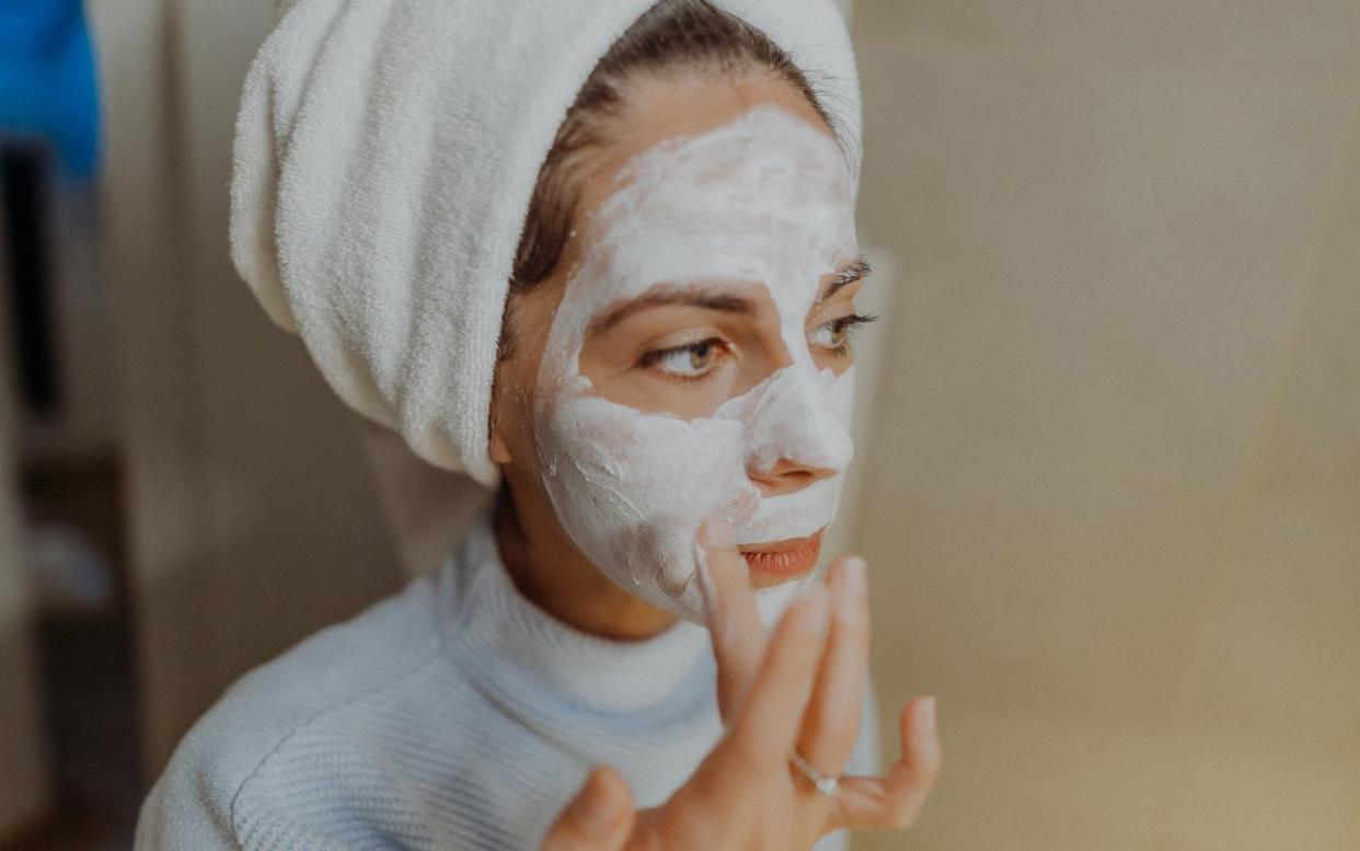 Woman applying face mask