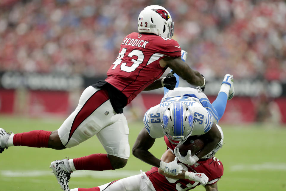 Detroit Lions running back Kerryon Johnson (33) is hit by Arizona Cardinals outside linebacker Haason Reddick (43) and cornerback Robert Alford during the first half of an NFL football game, Sunday, Sept. 8, 2019, in Glendale, Ariz. (AP Photo/Darryl Webb)