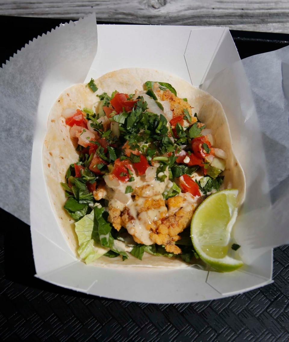 A soft-shell crab taco with lime prepared at the Funky Truckeria at 3200 Greenwich Road in Norton.