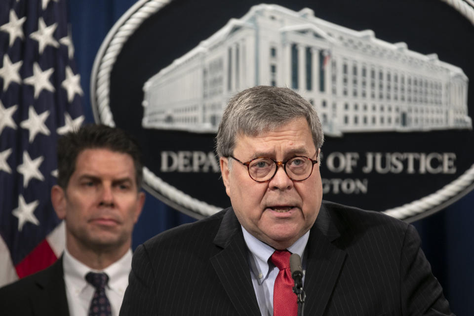 Attorney General William Barr, right, next to FBI Deputy Director David Bowdich, speaks during a news conference, Monday, Feb. 10, 2020, at the Justice Department in Washington. Four members of the Chinese military have been charged with breaking into the networks of the Equifax credit reporting agency and stealing the personal information of tens of millions of Americans, the Justice Department said Monday, blaming Beijing for one of the largest hacks in history. (AP Photo/Jacquelyn Martin)