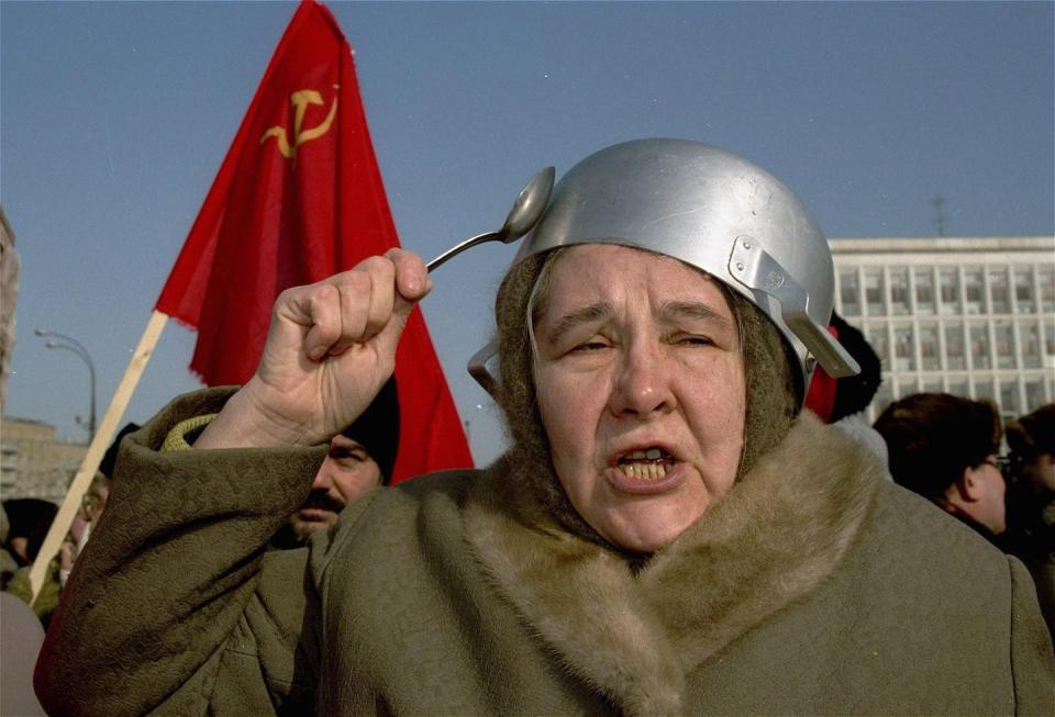 In this March 1993 photo, a woman in Moscow strikes a saucepan on her head with a spoon while shouting anti-Yeltsin slogans during a Women’s Day protest march against the cost of food. (AP Photo/Alexander Zemlianichenko)