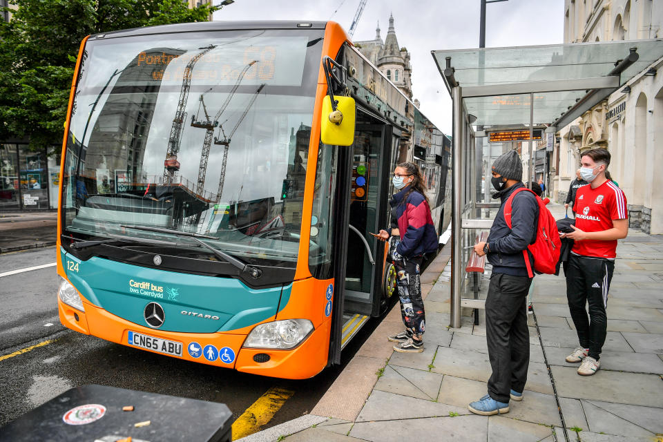 Passengers queue to board a bus in Cardiff as face coverings become mandatory on public transport in Wales to help prevent the spread of coronavirus. (Photo by Ben Birchall/PA Images via Getty Images)