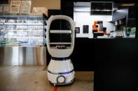 A robot that takes orders, makes coffee and brings the drinks straight to customers at their seats is seen at a cafe in Daejeon