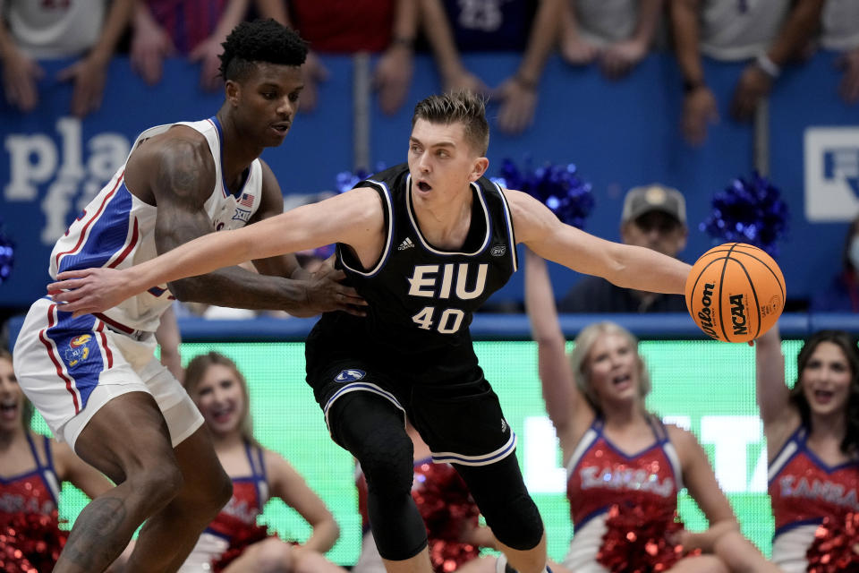 Kansas forward K.J. Adams Jr., left, pressures Eastern Illinois forward Kooper Jacobi (40) during the first half of an NCAA college basketball game Tuesday, Nov. 28, 2023, in Lawrence, Kan. (AP Photo/Charlie Riedel)