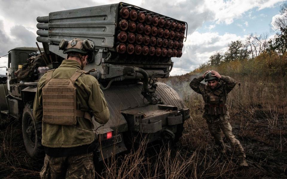 Ukrainian soldiers prepare to fire a BM-21 'Grad' multiple rocket launcher towards Russian positions in Kharkiv region - AFP