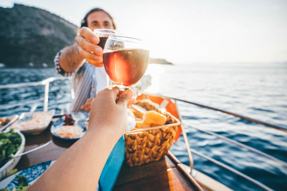 A couple clinking glasses on a boat