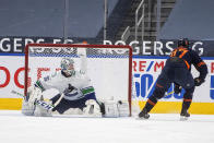 Edmonton Oilers' Connor McDavid (97) is stopped by Vancouver Canucks goalie Thatcher Demko (35) during the third period of an NHL hockey game Thursday, May, 6, 2021, in Edmonton, Alberta. (Jason Franson/The Canadian Press via AP)