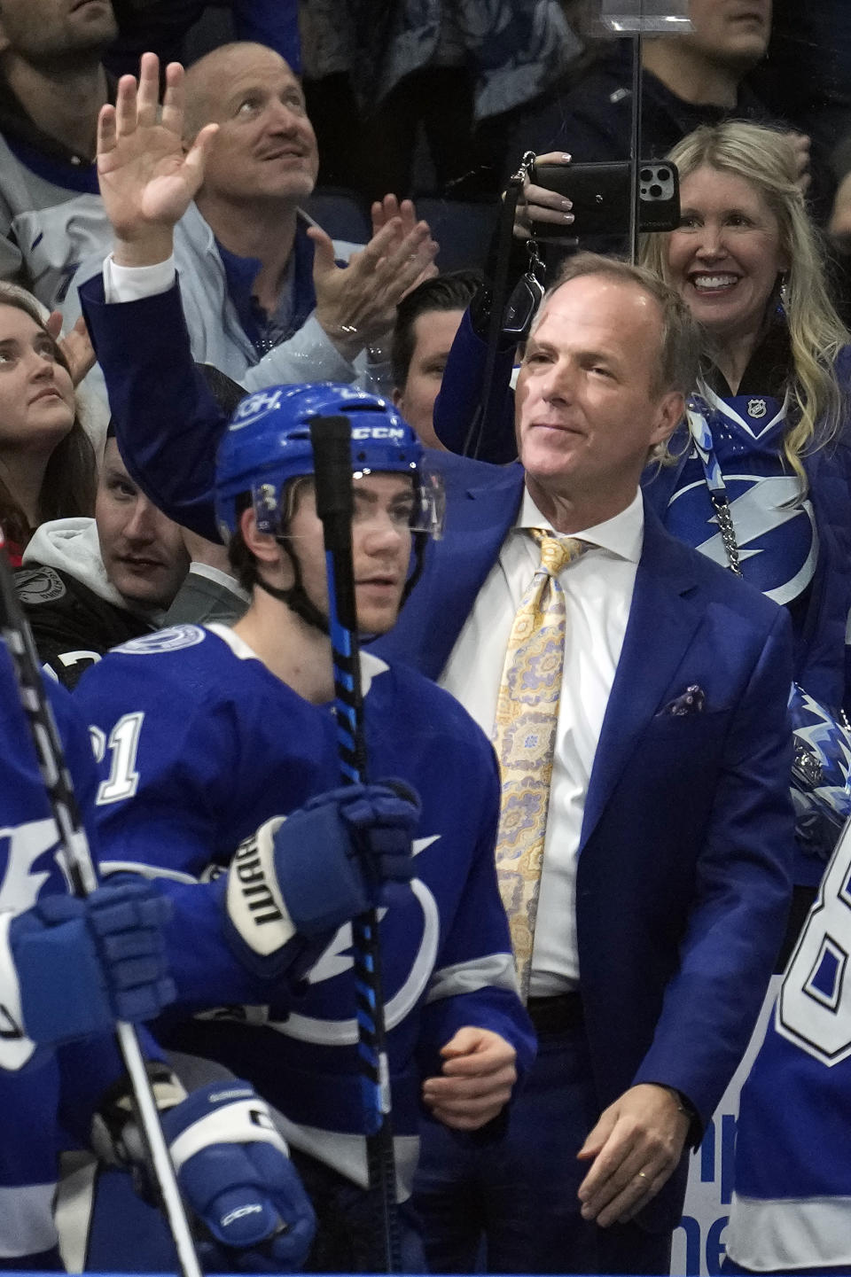 Tampa Bay Lightning head coach Jon Cooper waves to the crowd after being honored for his 500th win during the first period of an NHL hockey game against the New Jersey Devils Thursday, Jan. 11, 2024, in Tampa, Fla. (AP Photo/Chris O'Meara)