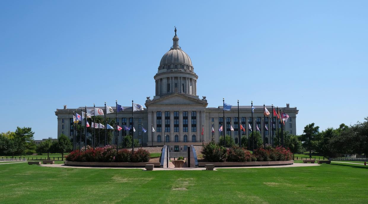 Flags representing the tribal nations based in Oklahoma fly outside the Oklahoma Capitol. Tensions over state-tribal relations have heightened this summer amid disputes over reservation status.