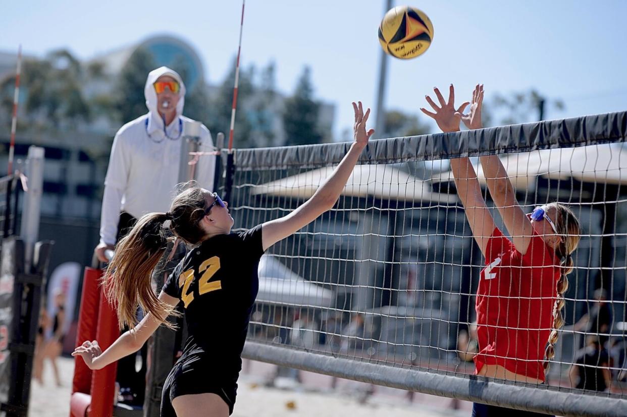 Mira Costa's Audrey Flanagan, left, tries to loft the ball over Redondo Union's Victoria Henkel.