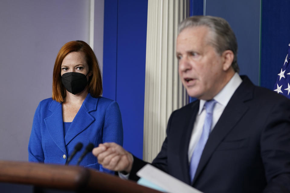 White House press secretary Jen Psaki, left, listens as Gene Sperling, who leads the oversight for distributing funds from President Joe Biden’s $1.9 trillion coronavirus rescue package, speaks during the daily briefing at the White House in Washington, Monday, Aug. 2, 2021. (AP Photo/Susan Walsh)