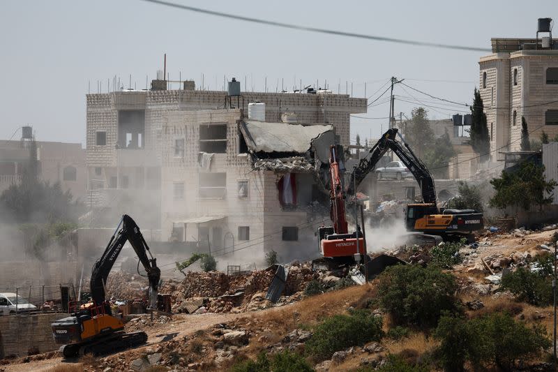 Israeli machinery demolishes a Palestinian house in Hebron