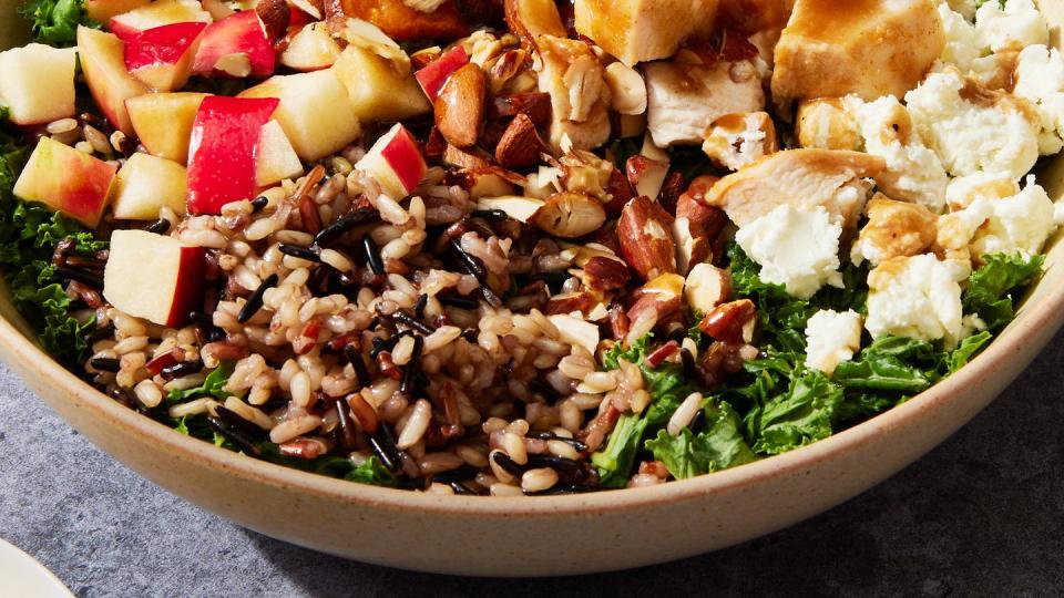 copycat sweetgreen harvest bowl with dressing drizzling over it from a spoon