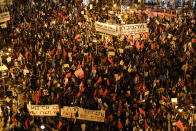 Protesters chant slogans and hold signs during a protest against Israel's Prime Minister Benjamin Netanyahu outside his residence in Jerusalem, Saturday, Oct. 17, 2020. Thousands of Israelis demonstrated outside Netanyahu's official residence for the first time in nearly a month, resuming the weekly protest after emergency restrictions imposed as part of a coronavirus lockdown were lifted. The protesters are demanding Netanyahu's resignation, saying he cannot serve while on trial for corruption charges and accusing him of mismanaging the country's coronavirus crisis. (AP Photo/Ariel Schalit)