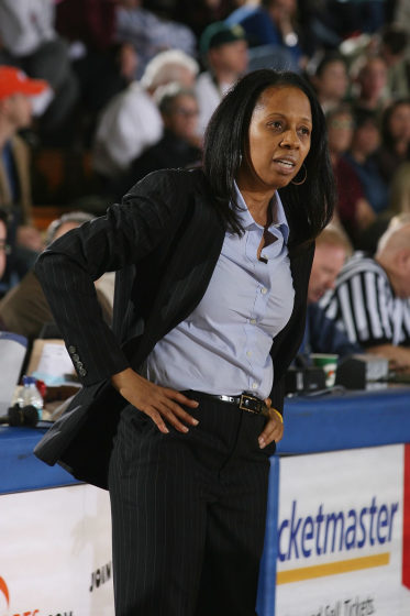 Pepperdine women's basketball coach Julie Rousseau instructs her players during a game.