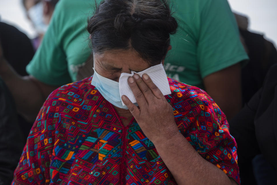 Manuela Coj Ixtos, the grandmother of Pascual Melvin Guachiac Sipac, cries as she watches his coffin arrive to the airport in Guatemala City, Friday, June 15, 2022. The 13-year-old was among a group of migrants who died of heat and dehydration in a trailer-truck abandoned by smugglers on the outskirts of San Antonio, Texas, on June 27. (AP Photo/Oliver de Ros)