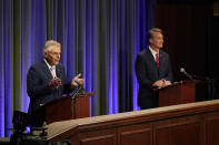 Democratic gubernatorial candidate and former governor Terry McAuliffe, left, gestures as his Republican challenger, Glenn Youngkin, looks on during a debate at the Appalachian School of Law in Grundy, Va., Thursday, Sept. 16, 2021. (AP Photo/Steve Helber)