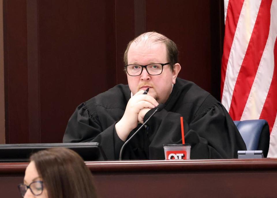 Judge William McKinnon listens during court Tuesday during a double murder trial.