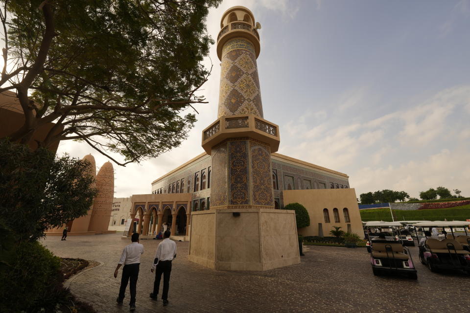 Two guards walk near Katara "Blue" mosque, in Doha, Qatar, Thursday, Dec. 8, 2022. (AP Photo/Jorge Saenz)