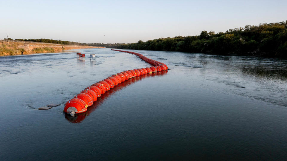 Buoys set on the international boundary between Mexico and the U.S. were placed by the State of Texas on the Rio Grande as a measure to prevent migrants seeking asylum from crossing into Eagle Pass, Texas from Piedras, Negras, Coahuila, Mexico. In this drone photo Eagle Pass, Texas is on the left side of the frame looking east downriver.