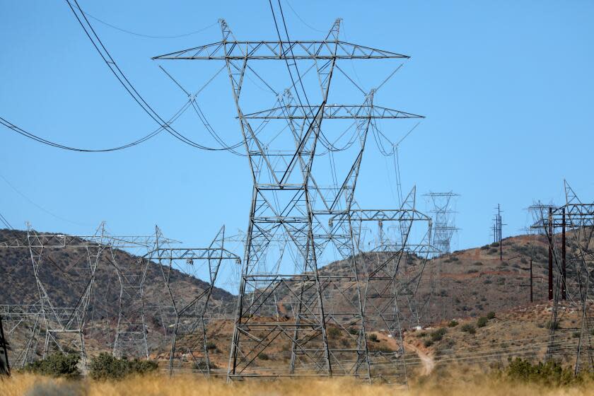 PALMDALE, CA - FEBRUARY 04: Electric transmission lines along a power corridor connecting to Southern California Edison's Vincent Substation on Thursday, Feb. 4, 2021 in Palmdale, CA. The lines cross over Highway 14. (Gary Coronado / Los Angeles Times)