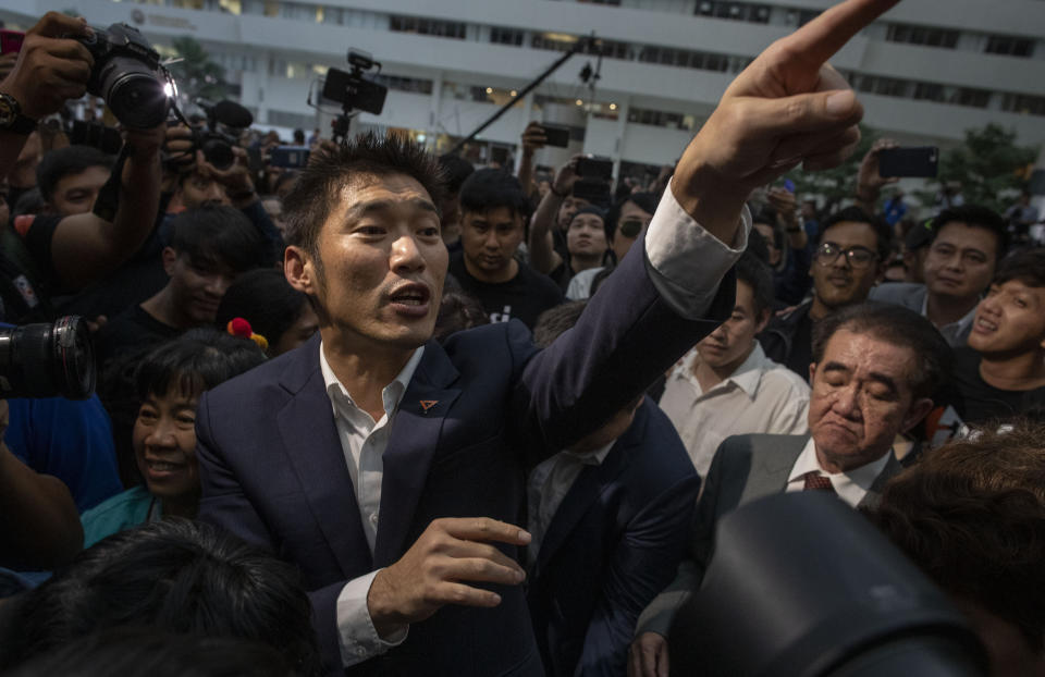 Thanathorn Juangroongruangkit, center leader of the anti-military Future Forward Party gestures as he leaves Constitutional Court in Bangkok, Thailand, Wednesday, Nov. 20, 2019. Thailand's Constitutional Court ruled Wednesday, that Thanathorn violated election laws and cannot keep his seat in Parliament. (AP Photo/Gemunu Amarasinghe)