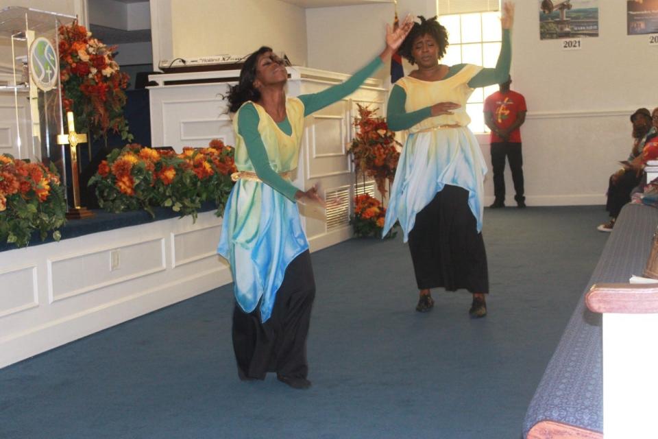 Desiree Waters, right, and Mechelle Waters, left, perform a liturgical dance during the Family and Friends Day service held Sunday at PASSAGE Family Church.