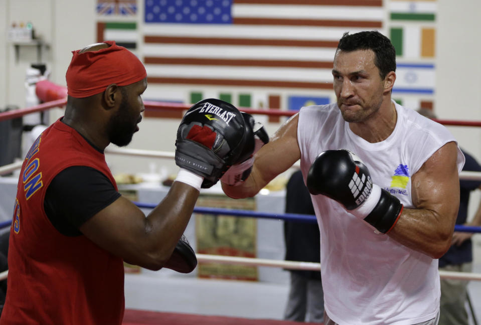 Undefeated heavyweight boxing champion Wladimir Klitschko, of Ukraine, right, trains with sparring partner Jonathon Banks, left, at the Lucky Street Boxing Gym, Thursday, March 20, 2014, in Hollywood, Fla. Klitschko is preparing for his upcoming fightApril 26 against Alex Leapai in Oberhausen, Germany. (AP Photo/Lynne Sladky)