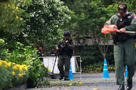 Police Explosive Ordnance Disposal (EOD) officers work following a small explosion at a site in Bangkok