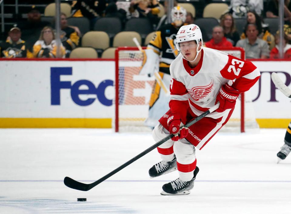 Detroit Red Wings left wing Lucas Raymond (23) handles the puck against the Pittsburgh Penguins during the first period at PPG Paints Arena in Pittsburgh on Wednesday, Oct. 4, 2023.