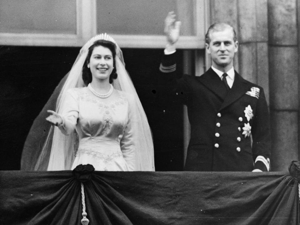 Queen Elizabeth and Prince Philip wave from the balcony of Buckingham Palace on their wedding day