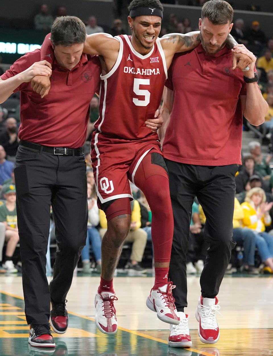 Oklahoma guard Rivaldo Soares (5) is helped off the court during the second half of an NCAA college basketball game against Baylor in Waco, Texas, Tuesday, Feb. 13, 2024. (AP Photo/LM Otero)