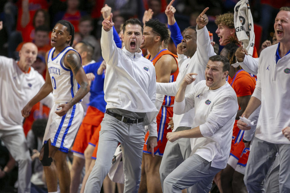 Florida head coach Todd Golden celebrates as Kentucky Wildcats guard Rob Dillingham (0) goes out of bounds during the first half of an NCAA college basketball game Saturday, Jan. 6, 2024, in Gainesville, Fla. (AP Photo/Alan Youngblood)