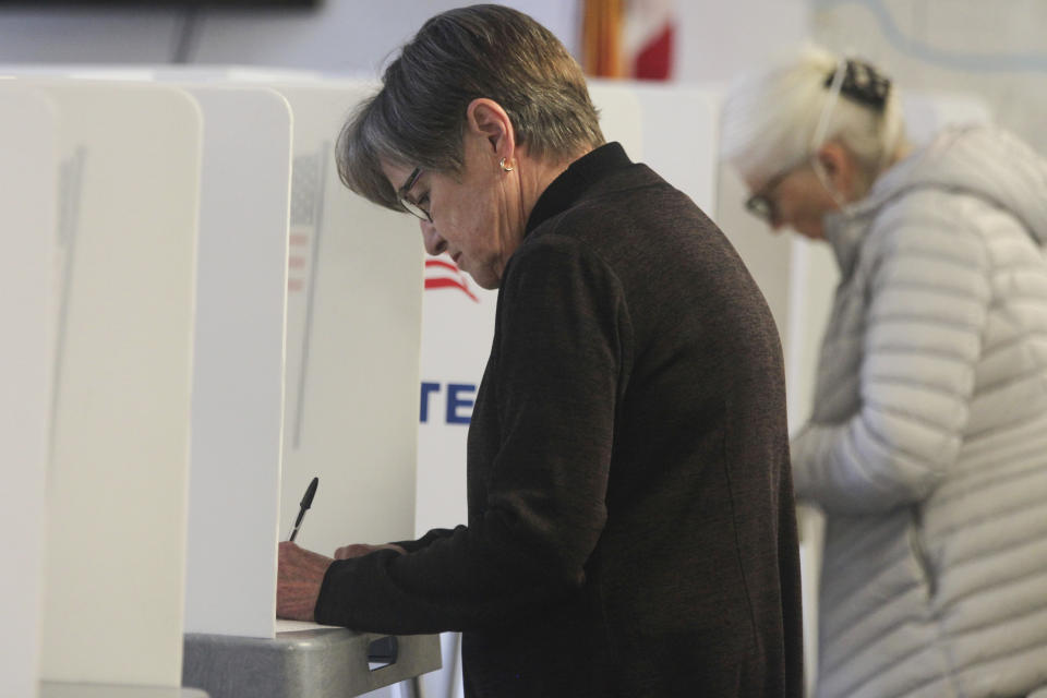 Kansas Gov. Laura Kelly fills out an advance ballot at the Shawnee County Election Office on Tuesday, Oct. 25, 2022, in Topeka, Kan. Kelly, a Democrat, says she opposes a proposed amendment to the Kansas Constitution to make it easier for the Republican-controlled Legislature to overturn agency rules, predicting it will lead to "chaos." (AP Photo/John Hanna)