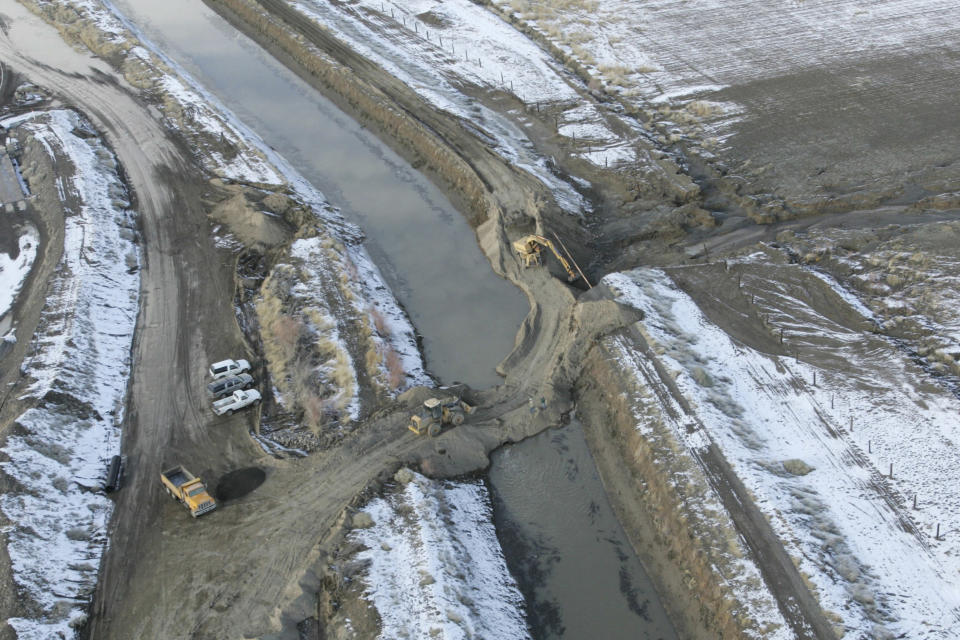 FILE -- A levee that broke flooding homes and forcing evacuations is shown in the process of being repaired in Fernley, Nev., on Jan. 6, 2008. A U.S. appeals court has breathed new life into a rural Nevada's town's unusual bid to halt government repairs to an aging, federal irrigation canal that burst and flooded nearly 600 homes 15 years ago. The town of Fernley, area farmers and ranchers in the high desert 30 miles (48 kilometers) east of Reno say the renovation that finally began this year might help guard against another failure of the 118-year-old earthen canal. (AP Photo/Brad Horn, File)