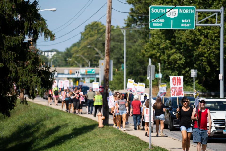 CEA union members and supporters march outside of Whetstone High School on Tuesday. Some Columbus City Schools families have decided to not cross the "virtual picket line" when online learning begins at most schools Wednesday.