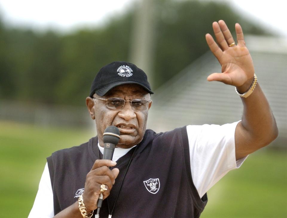 Jimmy Raye waves to campers at the Jimmy Raye football camp at E.E. Smith High Schoo, June 29, 2004.