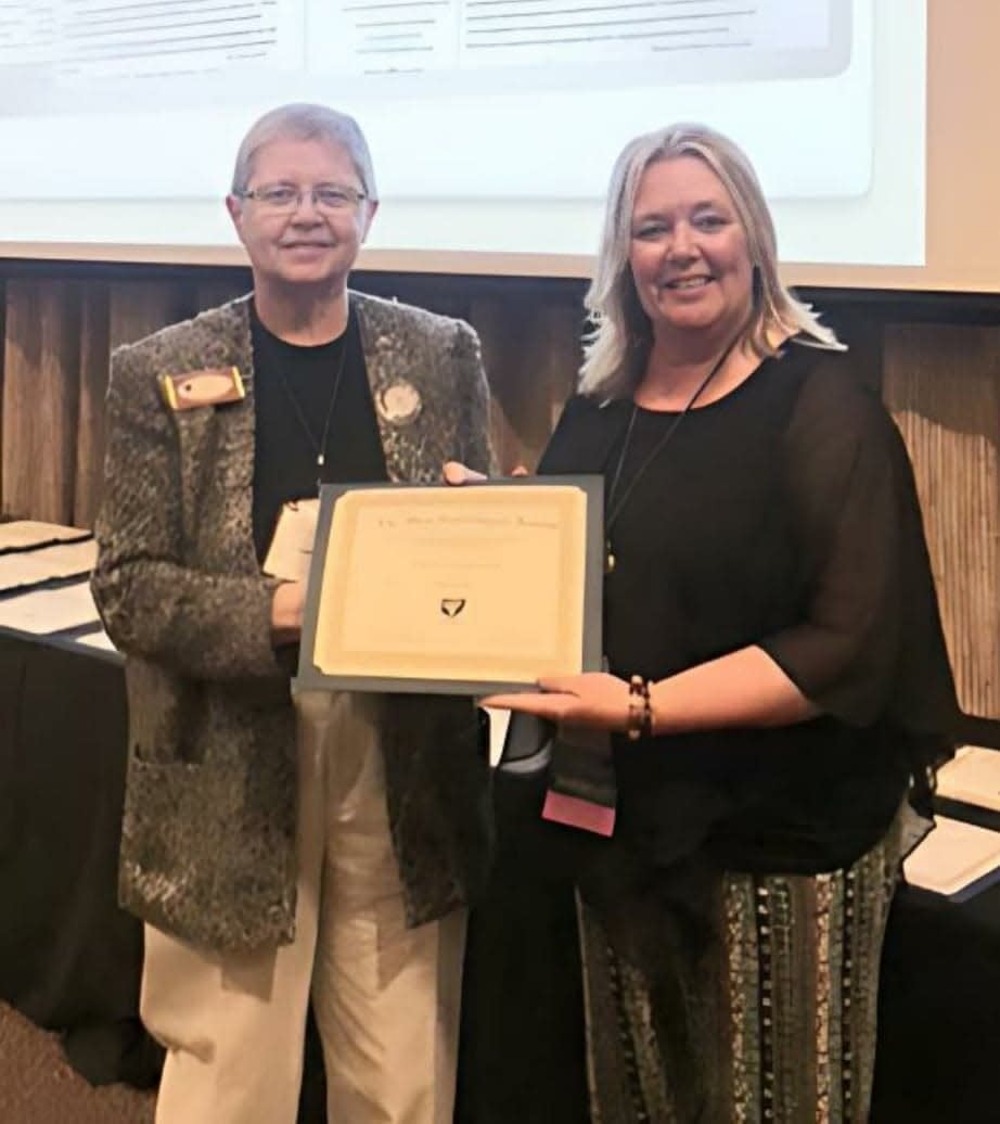 Pictured is Ohio Genealogy Society President Dot Martin presents Ashland County Chapter President Tammy Sloan Pelton with the OGS Chapter of the Year award.
