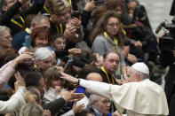 Pope Francis salutes faithful in the Paul VI Hall at the Vatican at the end of an audience with members of parish evangelization services, Monday, Nov. 18, 2019. (AP Photo/Alessandra Tarantino)