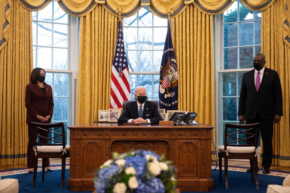 President Joe Biden, joined by Vice President Kamala Harris and Secretary of Defense Lloyd Austin, in the Oval Office of the White House on January 25, 2021. / Credit: JIM WATSON/AFP via Getty Images