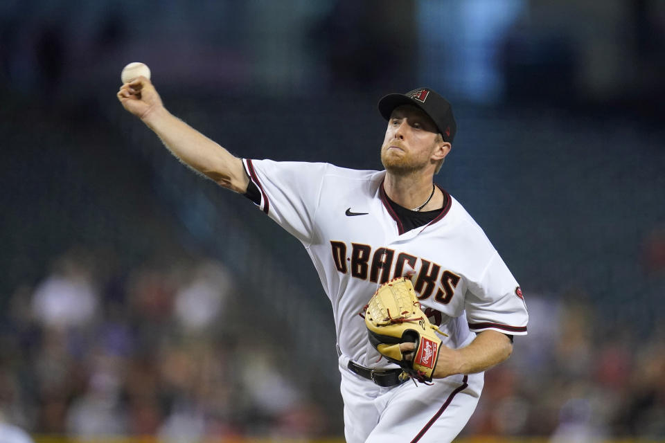 Arizona Diamondbacks starting pitcher Merrill Kelly throws to a San Francisco Giants batter during the first inning of a baseball game Thursday, July 1, 2021, in Phoenix. (AP Photo/Ross D. Franklin)