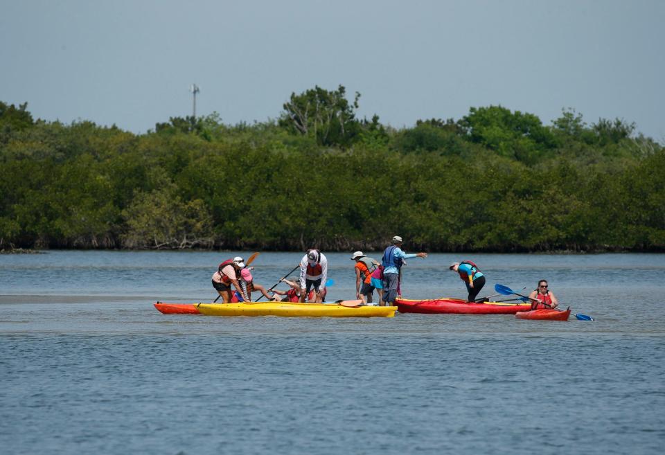 Kayakers along the river in Edgewater, Friday, April 9, 2021.   