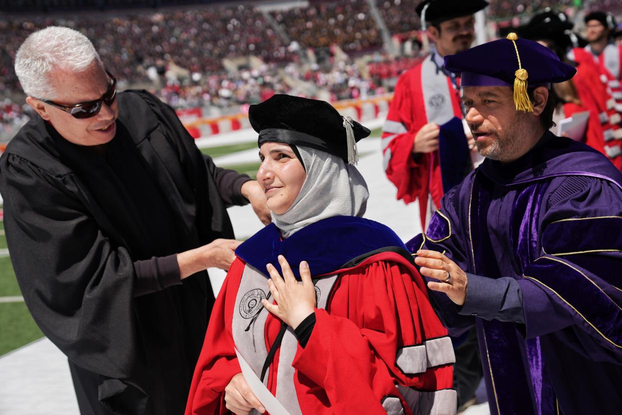 Mathematics Ph.D graduate Ayer Ababneh receives her doctoral hood Sunday during Ohio State spring commencement at Ohio Stadium.