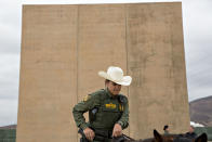 <p>A U.S. Border Patrol agent sits on a horse in front of a U.S.-Mexico border wall prototype while patrolling in San Diego, Calif., on Monday, Oct. 30, 2017. (Photo: Daniel Acker/Bloomberg via Getty Images </p>