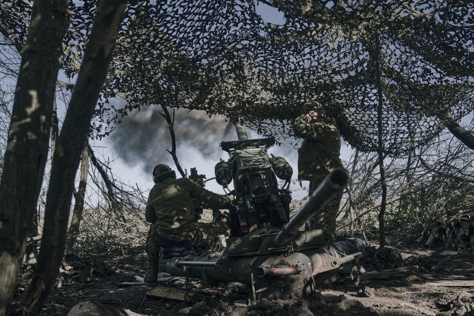 FILE - Ukrainian soldiers fire a cannon near Bakhmut, an eastern city where fierce battles against Russian forces have been taking place, in the Donetsk region, Ukraine, Wednesday, May 3, 2023. The owner of Russia’s Wagner Group military contractor is threatening to pull his troops out of the protracted battle for the eastern Ukraine city of Bakhmut next week. He accused Russia’s military command Friday, May 5 of starving his forces of ammunition and rendering them unable to fight. (AP Photo/Libkos, file)