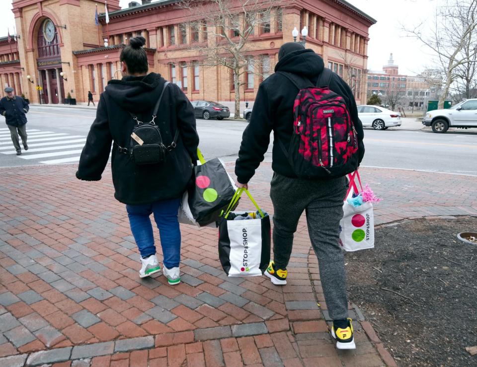 Shanelle Saraceno and her boyfriend, Dylan Ballou, leave Burnside Park with all their possessions stuffed in grocery bags.