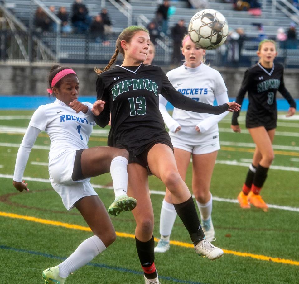 Nipmuc Regional High School 's Anya Montano, #13, competes for the ball Auburn's Katelynn Taylor at the Central Mass Athletic Directors Association Class B girls soccer championship at the Assabet Valley Regional High School field, Nov. 1, 2023.